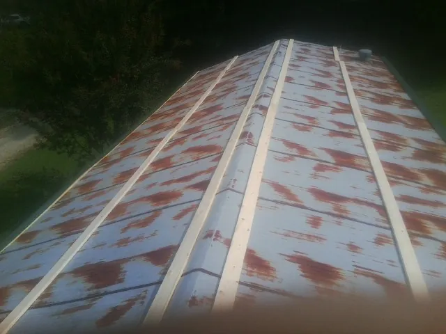 Rusted metal roof panels with new wood purlins before replacement — Storm Damage Roof Repair in Beaufort by Roofing Brothers