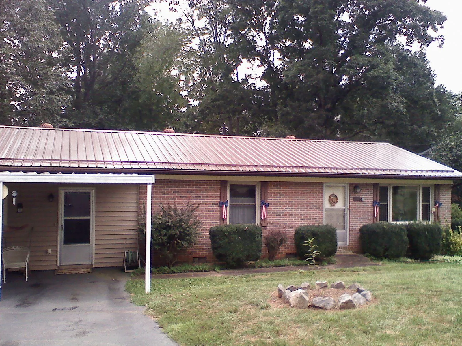 Bronze metal roof and carport on a brick ranch home — Roof Repair work by our crew in Beaufort