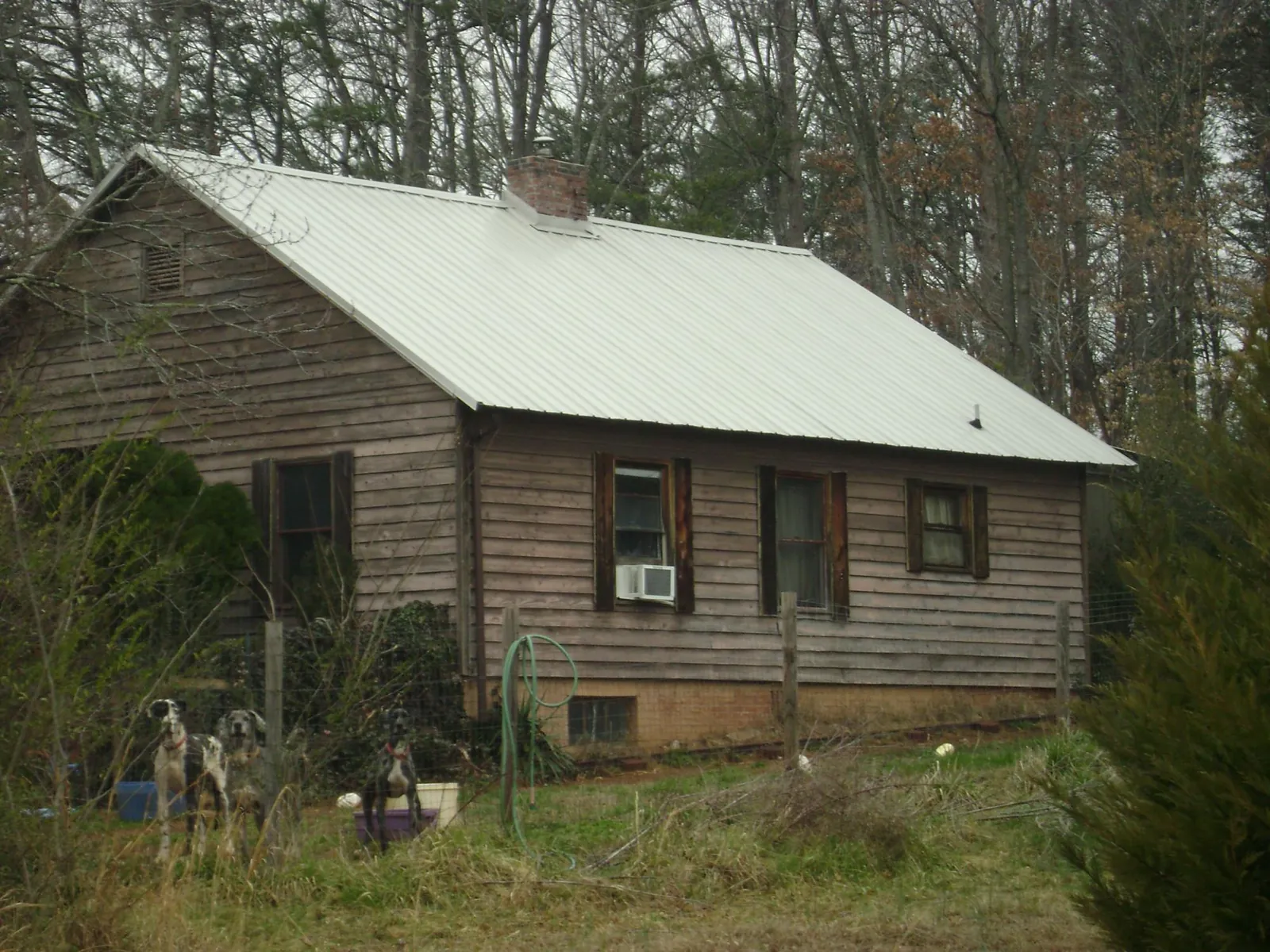 White metal roof on an old wood sided farmhouse, from a Metal Roof Installation job in Beaufort